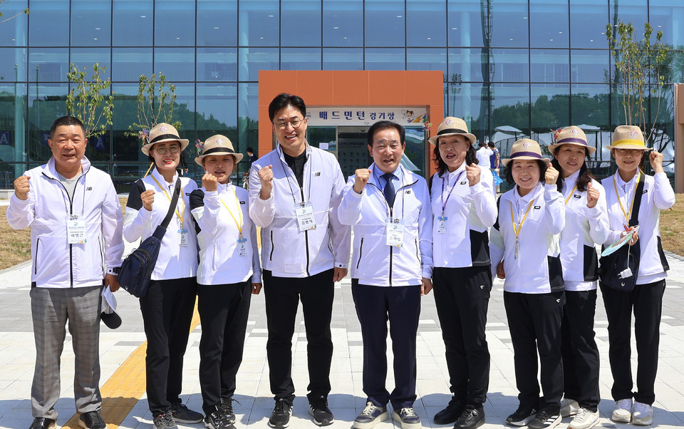 김명식 진천군 체육회장(왼쪽 네 번째)이 탁구경기장 앞에서 자원봉사자들을 격려후 화이팅을 외치고 있다.