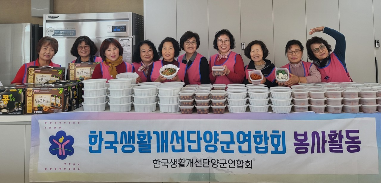 ▲ 한국생활개선 단양군연합회원들이 이웃에 전달할 반찬을 만들고 전달에 앞서 사진촬영을 하고 있다. 사진=단양군제공