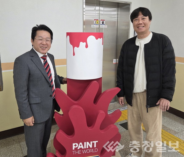 ▲ 권진수 마루 광고 디자인 대표(오른쪽)가 7일 충북 진천군 진천읍 행정복지센터에서 임병곤 진천읍장에게 자신의 작품을 기증하고 있다.