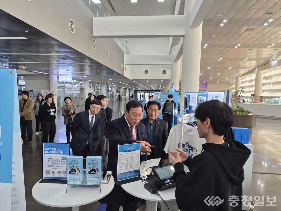 ▲ 최민호 세종시장(가운데)이 24일 세종시청 로비에서 열린 ‘2027 충청 유니버시아드대회’ 공식 굿즈 팝업 행사장을 방문해 상품을 둘러보고 관계자로부터 설명을 듣고 있다